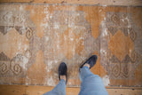 Distressed Oushak rug runner with textured pile, rams horn guls, in gold and charcoal.