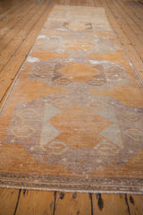 Distressed Oushak runner detail: rams horn guls, abrashed gold, silver, and ivory pile texture.