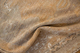 Distressed Oushak rug detail showing visible knot heads, low pile, gold, saffron, and ivory tones.