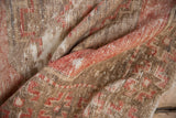 Detail of Vintage Distressed Oushak rug: blush red geometric patterns, worn pile, visible foundation.