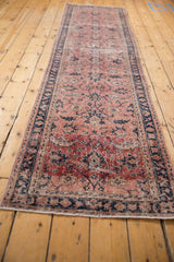 Distressed vintage Sparta runner, allover floral vines in dusty blush, red, and cobalt blue.