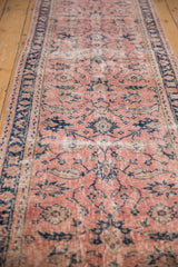 Distressed vintage Sparta runner, showing foundation wear, dusty blush field, and cobalt blue floral elements.