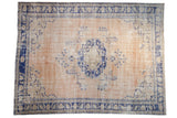 Distressed Oushak carpet with abrashed beige field, cobalt medallion, vines, blossoms, asymmetric border, 8'2