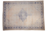 Distressed Oushak rug with faded cobalt blue diamond medallion on an ivory abrashed field, 8'7