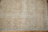 Distressed vintage Oushak rug corner with muted sand, pale rust patterns, short pile, original selvage.