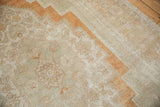 Distressed vintage Oushak carpet with soft plush pile, abrashed ground, and burnt orange border.
