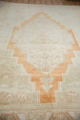 Soft plush short pile of vintage distressed Oushak carpet with stepped medallion.