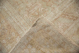 Distressed vintage Oushak rug corner showing plush pile, hand-knotted foundation, and fringe.