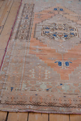 Distressed vintage Oushak runner detail, terracotta and sand floral motifs with even wear.