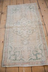 Vintage distressed Oushak rug runner showing wear to foundation, pale rose, seafoam green.