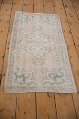 Distressed side selvage of Oushak rug runner with faded pale rose and seafoam green.