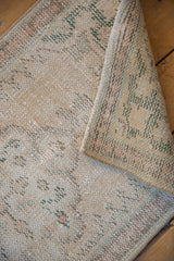 Distressed vintage Oushak rug pile revealing wear to foundation and original selvage.