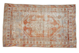 Distressed vintage Oushak rug with faded terracotta medallion, pale blue field, and stepped spandrels, 3'3
