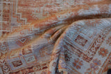 Distressed texture of vintage Oushak rug with faded rust, ivory, and pale blue hues.