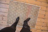 Distressed Oushak rug with faded floral lattice pattern, beige and pink abrashes.