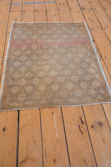 Distressed corner of vintage Oushak rug with abrashes, faint foundation, and intact side selvage.
