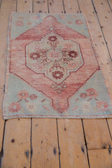 Scalloped medallion with inner floral bouquet on a vintage distressed Oushak rug.