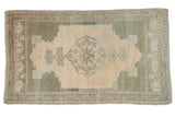 Beige and sage distressed Oushak rug with center medallion, floral pinwheel designs. 3x5.