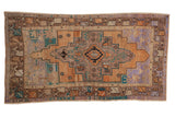 Vintage distressed Oushak rug, stepped medallion, geometric floral motifs in terracotta, blue, and soft lavender. 3'9