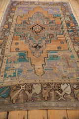 Distressed vintage Oushak rug border with worn brown, beige, and dusty turquoise patterns.