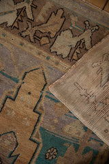 Distressed vintage Oushak rug's pile showing even wear, geometric patterns, and hand-knotted reverse.