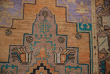 Distressed Oushak rug detail, stepped geometric pattern in muted sandalwood, lavender, turquoise.