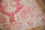 Distressed vintage Oushak rug with cherry red lattice and ivory worn pile.