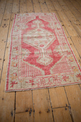 Vintage Distressed Oushak rug corner with red lattice and faded floral motifs, fringe.