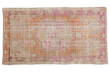 Vintage Distressed Oushak rug with faded scalloped medallion, floral patterns, in sandalwood, copper, fuchsia.