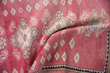Distressed Oushak rug texture: blush red field, ivory diamonds, oxidized silver floral motifs.