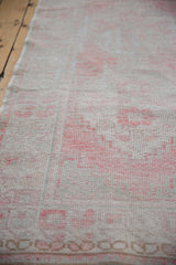 Distressed vintage Oushak runner pile, with blush tones and faint foundation showing.