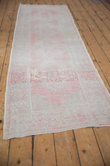 Distressed blush and ivory geometric border with restored selvage on Oushak runner.
