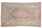 Vintage Distressed Oushak carpet with faded seafoam green, aubergine, and ivory stepped medallion. 5'7