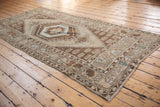 Distressed vintage Oushak runner corner shows beige and brown lightning stepped spandrel and borders.