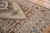 Distressed Oushak runner with lightning stepped corner spandrel and meandering floral borders.