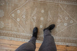 Distressed Oushak rug runner texture with pale coffee brown and ivory floral guls.
