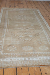 Worn pile texture of vintage Oushak runner, with pale coffee floral guls and serrated border.