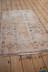 Vintage Distressed Oushak rug with muted beige field, blush germinating plants, and time-softened floral borders.