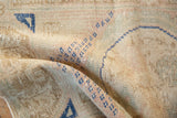Distressed Oushak rug pile, showing mostly even wear with cobalt blue geometric patterns.