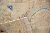 Distressed Oushak rug pile showing knot heads, cobalt blue design, and hand-knotted foundation.