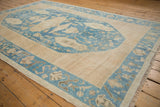 Distressed denim blue and ivory Oushak carpet with varied floral designs, short pile.
