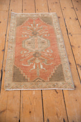Distressed vintage Oushak rug corner with coffee brown stepped spandrel and worn terracotta.