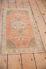 Close-up of distressed Oushak rug corner, showing stepped spandrel in terracotta and sandalwood.