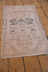 Vintage distressed Oushak rug with faded floral vinery, charcoal lines, and abrashes.