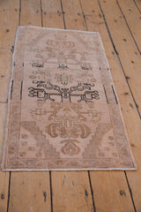 Distressed vintage Oushak rug with prominent black geometric motif and soft beige abrashes.