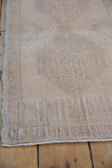 Distressed vintage Oushak rug texture, ivory, pale beige tones, even pile wear, faint foundation.