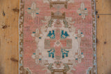 Distressed vintage Oushak rug pile with even wear, dusty rose, ivory, and turquoise floral motifs.