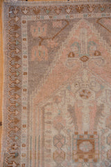 Distressed vintage Oushak rug side border with geometric design and faded beige and blue.