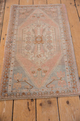 Distressed Oushak rug corner spandrel featuring soft beige, pink, and powder blue floral blossoms.