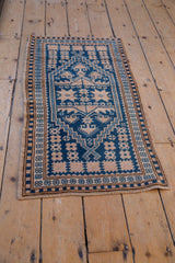 Vintage distressed Oushak rug with cobalt blue and ivory geometric stepped medallion.